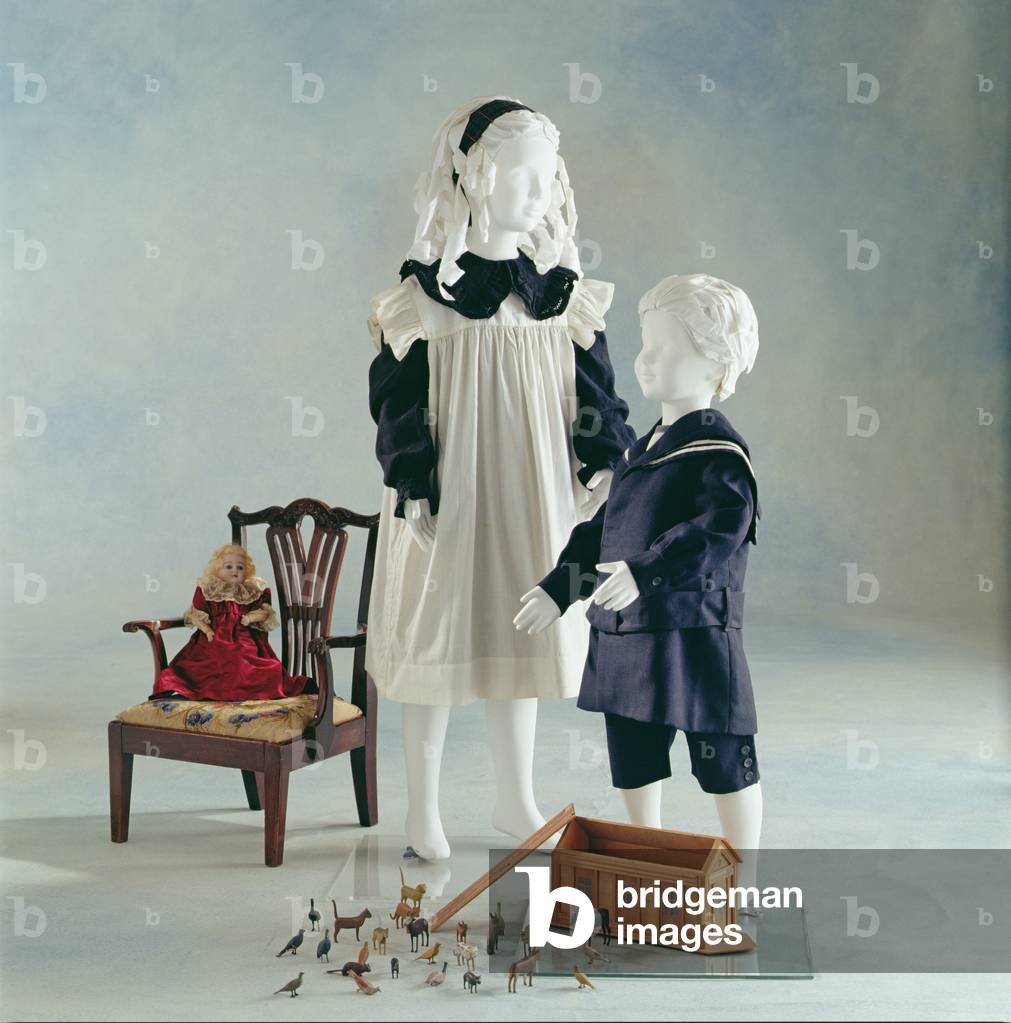 A girl's black wool mourning dress with frilled collar and smocking on the cuff, c.1900-05; and A boy's wool sailor suit, c.1910 (photo)
