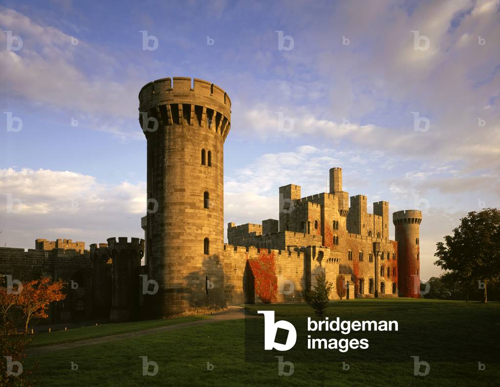 The west front of Penrhyn Castle, lit by a low sun (photo)