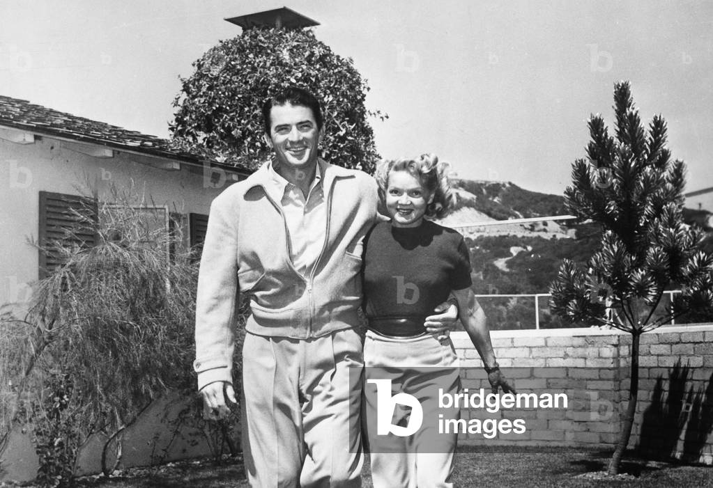 American actor Gregory Peck with his wife Greta in their garden, 1950s