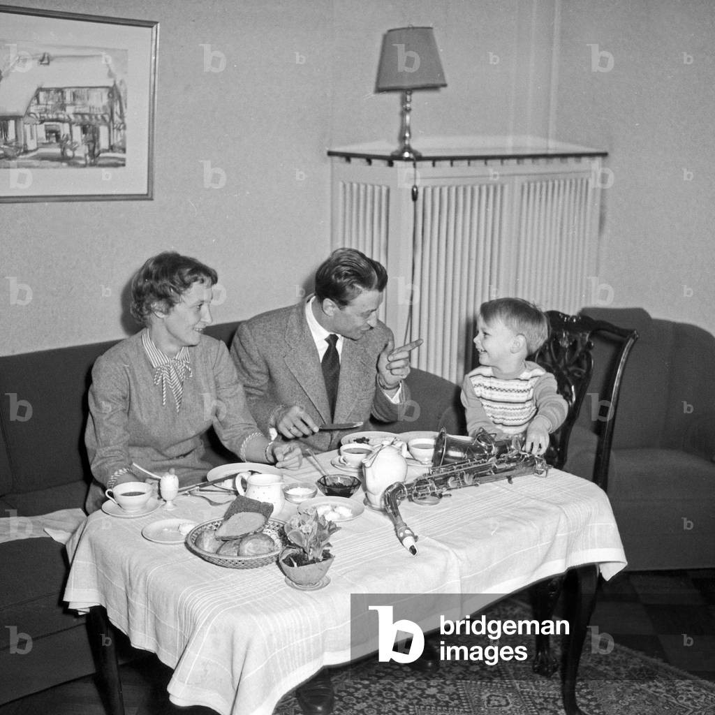 Breakfast with the family at home of German clarinetist Hugo Strasser with his saxophone