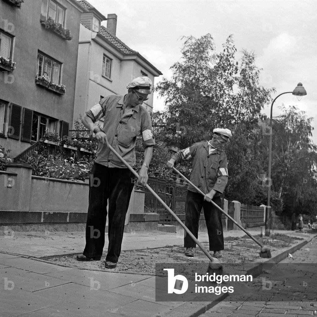 Men of the public street cleaning on the streets of Hamburg, Germany 1960s