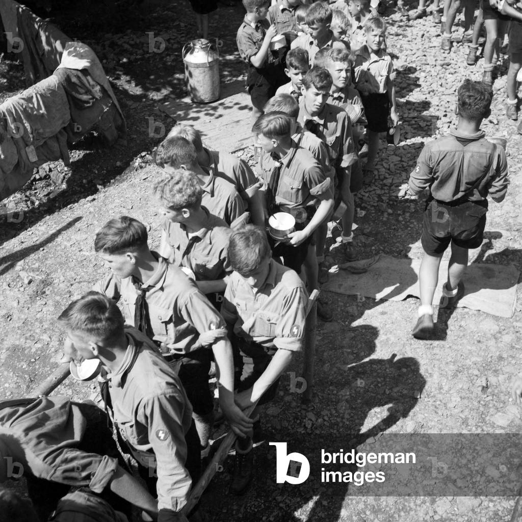 Hitler youth queueing for lunch in their camp near Spitz, Lower Austria, Austria 1930s (b/w photo)