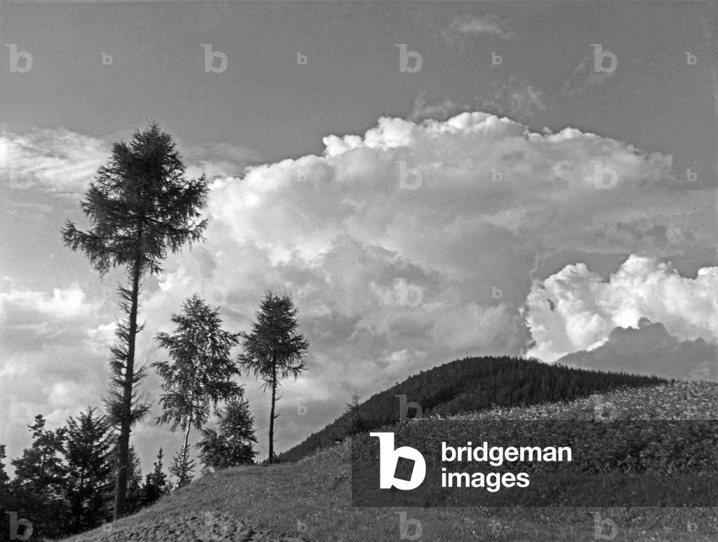 A landscape with a flock of clouds in the sky, Germany 1930s (b/w photo)