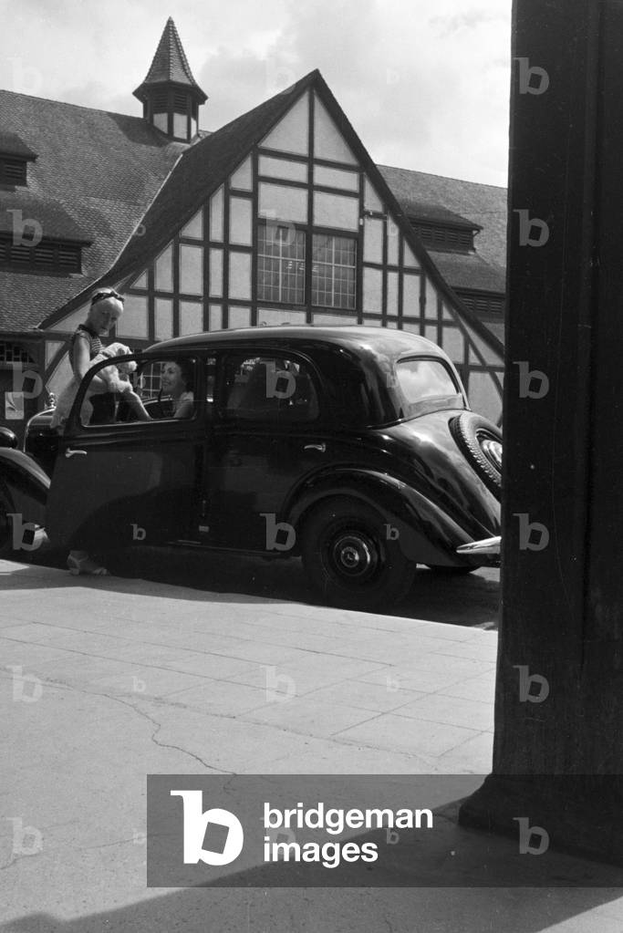 Two young women arriving in Uhlbach, a district of Stuttgart , Germany 1930s (b/w photo)