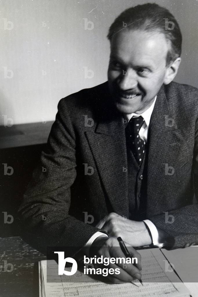 Portrait of one of the Diehl brothers and founders of the hedgehog character Mickie working on the skript of the animated movie The Race between the Rabbit and the Hedgehog, Germany 1930s (b/w photo)