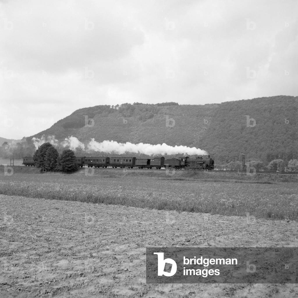 A passenger train on its way through Westfalia, Germany 1930s (b/w photo)