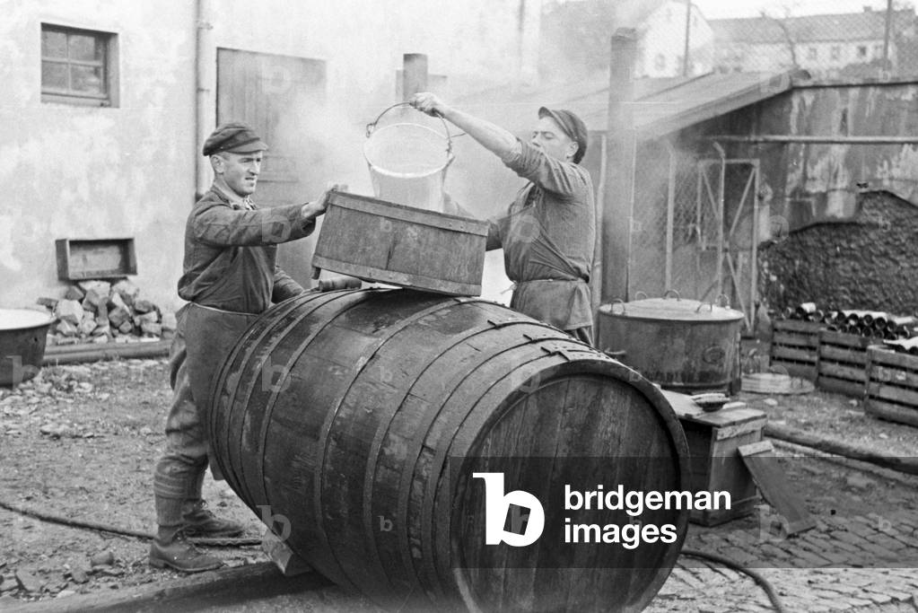 Coopers constructing a barrel fro the new harvested wine at Serrig, Germany 1930s (b/w photo)
