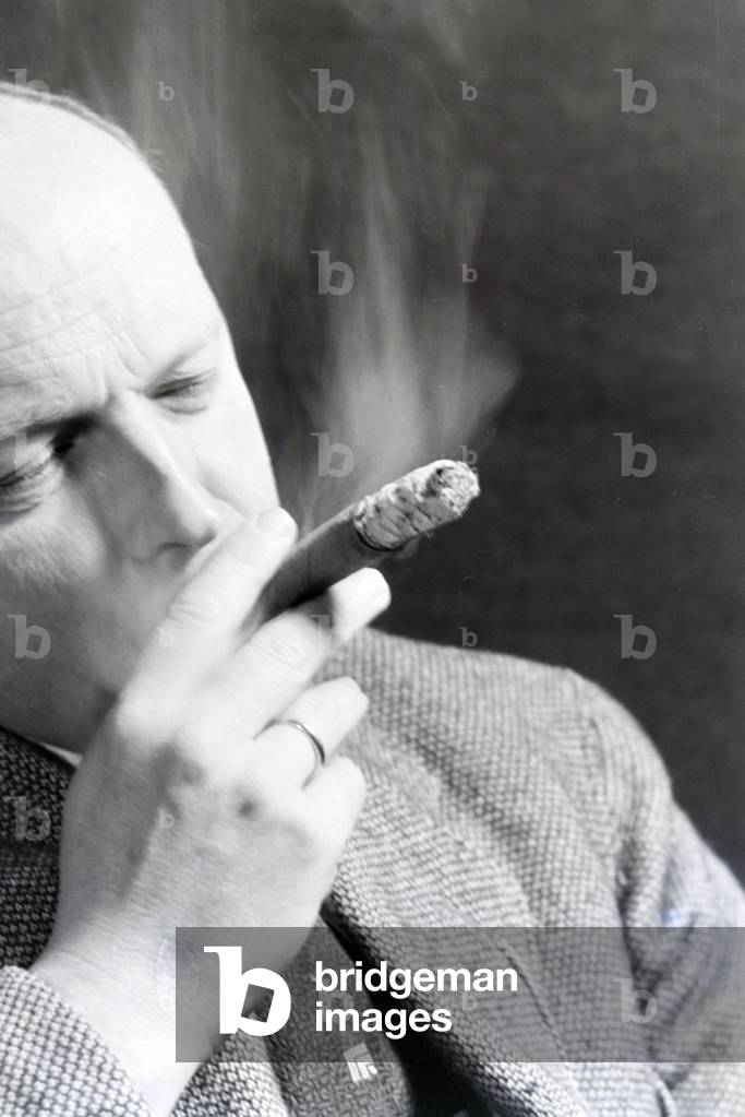 A man smoking a cigar for an advertising campaign, Germany 1930s (b/w photo)