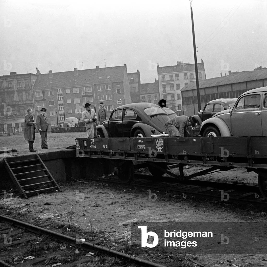 Volkswagen beetles being unloaded from the transport from Volkswagenwerk factory at Wolfsburg, Germany 1950s
