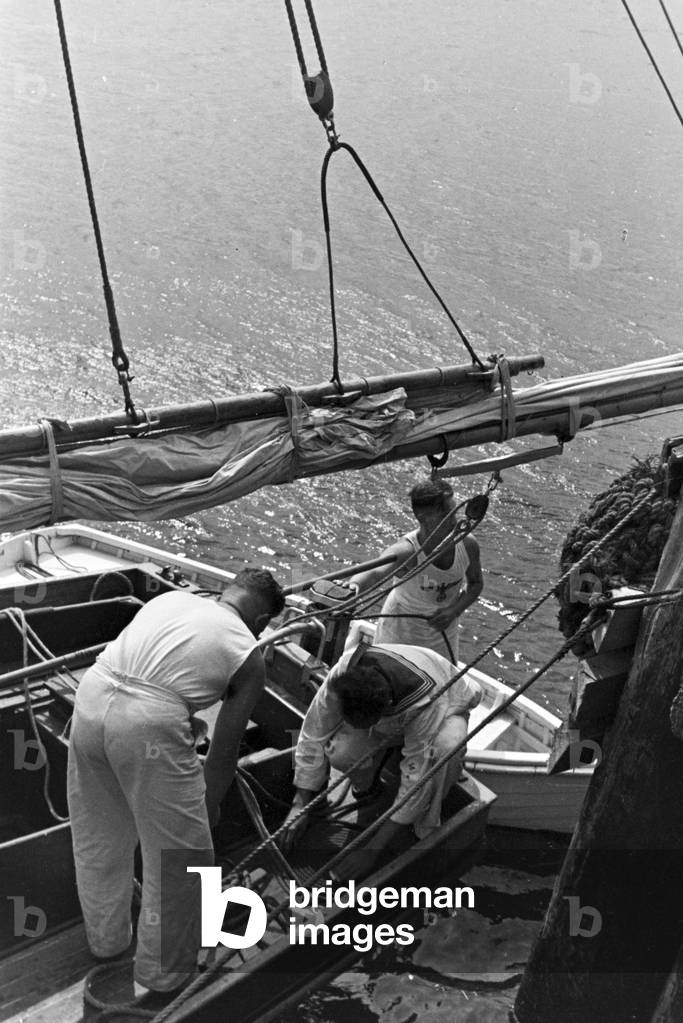 Men on board of a sailing boat on the Baltic Sea, Germany 1930s (b/w photo)