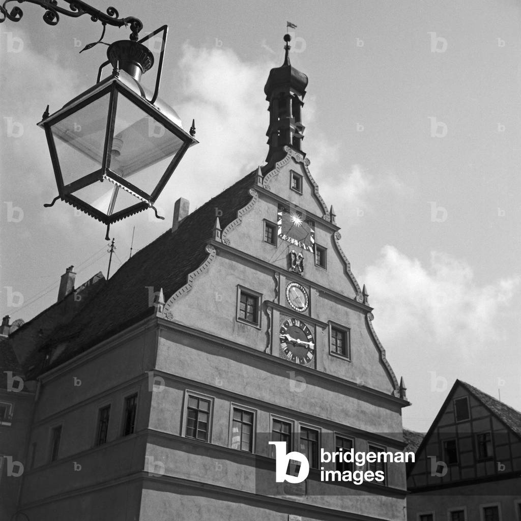 Scenic old city building with mechanical clock and sundial at Rothenbrg ob der Tauber, Germany 1930s (b/w photo)
