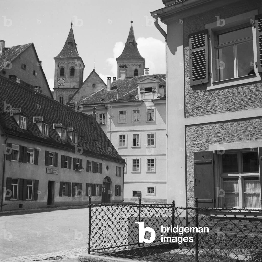 Twin towers of a church above the roof of a small town, Germany 1930s (b/w photo)
