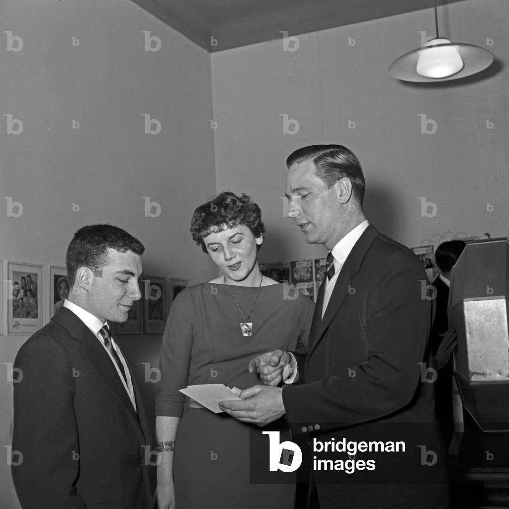 A woman and two men with a lottery wheel, Germany 1950s