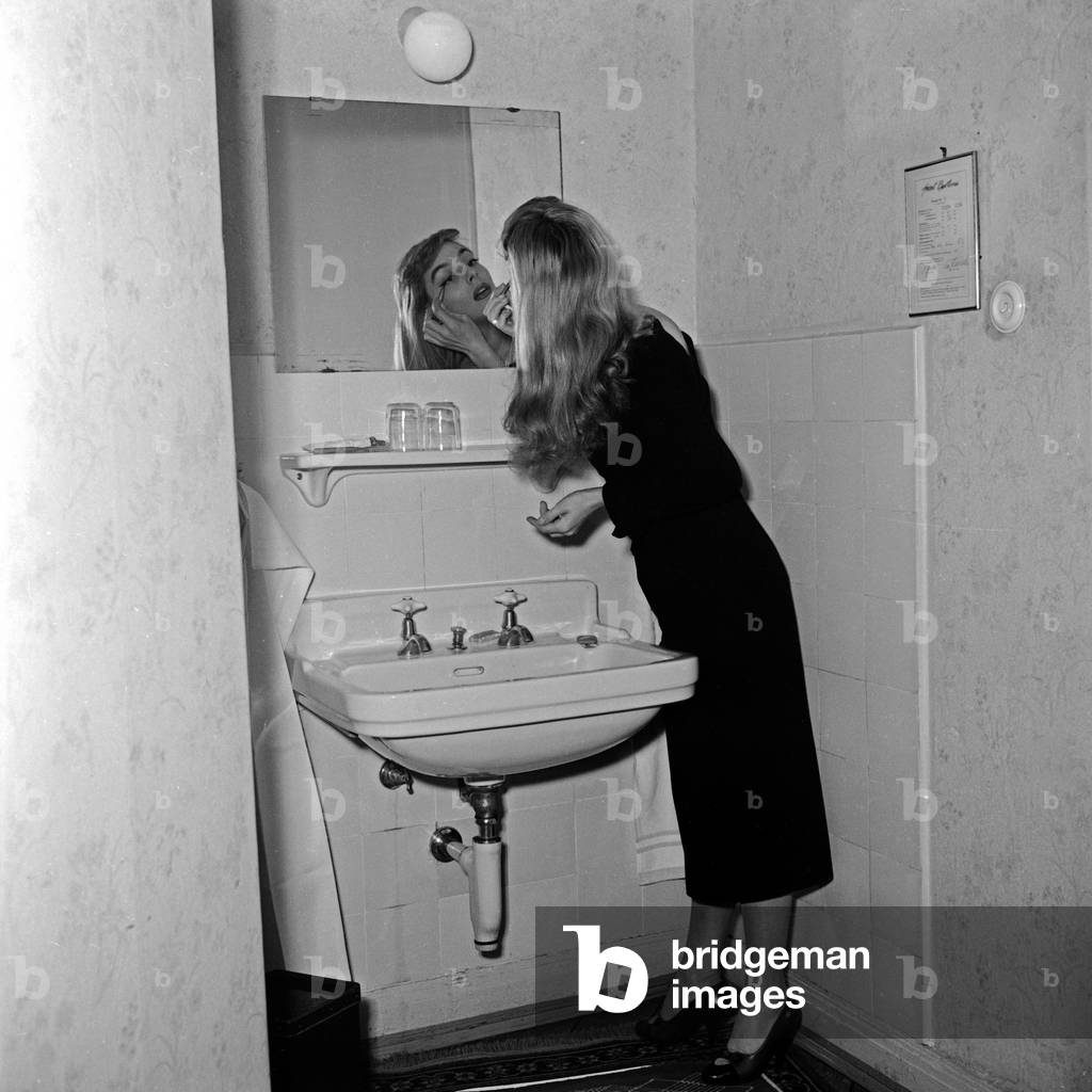 French singer Daniele Dupre at a photo shoot in her hotel room at Hamburg, Germany 1950s