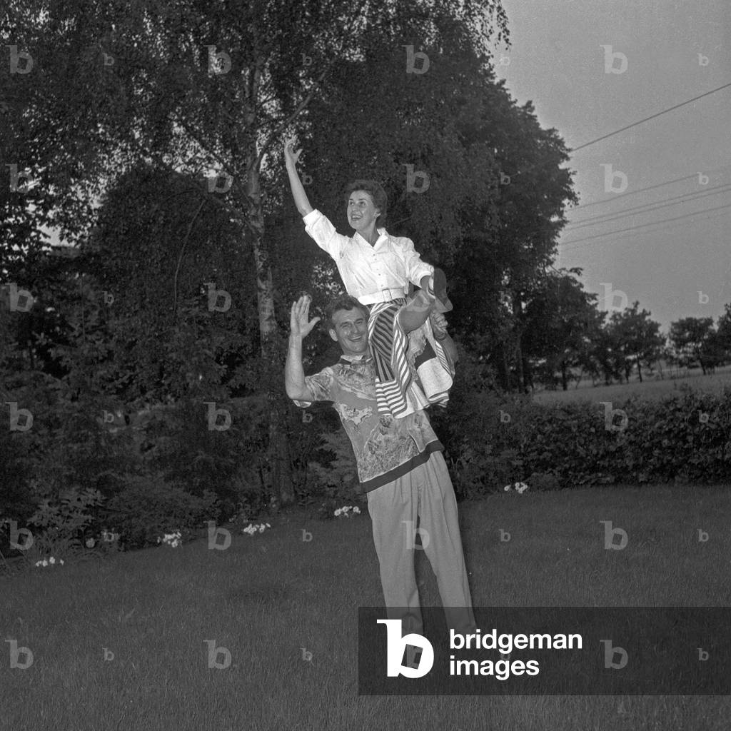 German duo in their garden at dawn at Hamburg, Germany 1950s