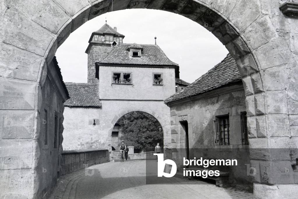 One of the many historical archways in Rothenburg ob der Tauber, Germany 1930s (b/w photo)