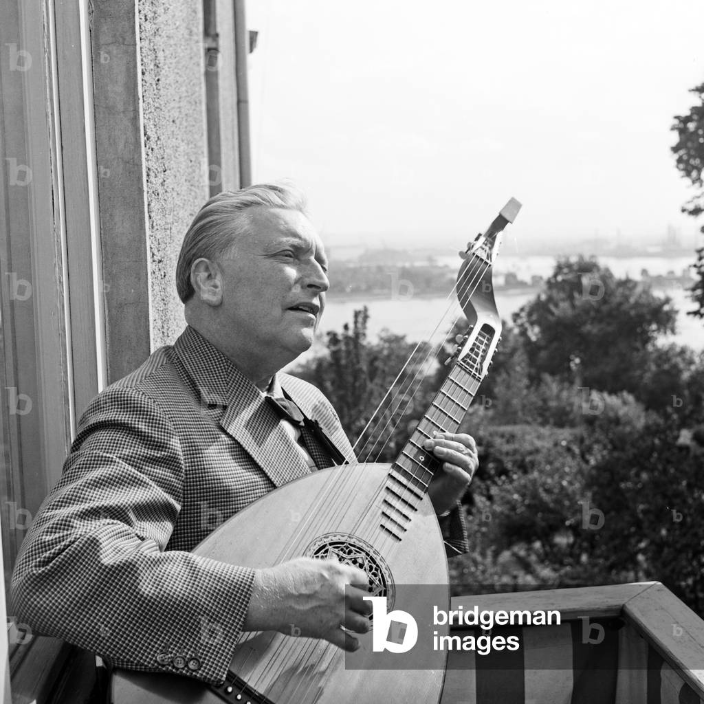 German lutenist Richard Germer playing his lute on a balcony at Hamburg, Germany 1950s