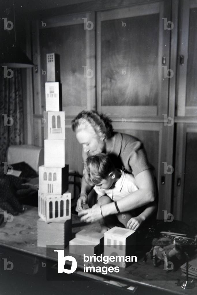 An artisan showing new toys to a boy, Germany 1930s (b/w photo)