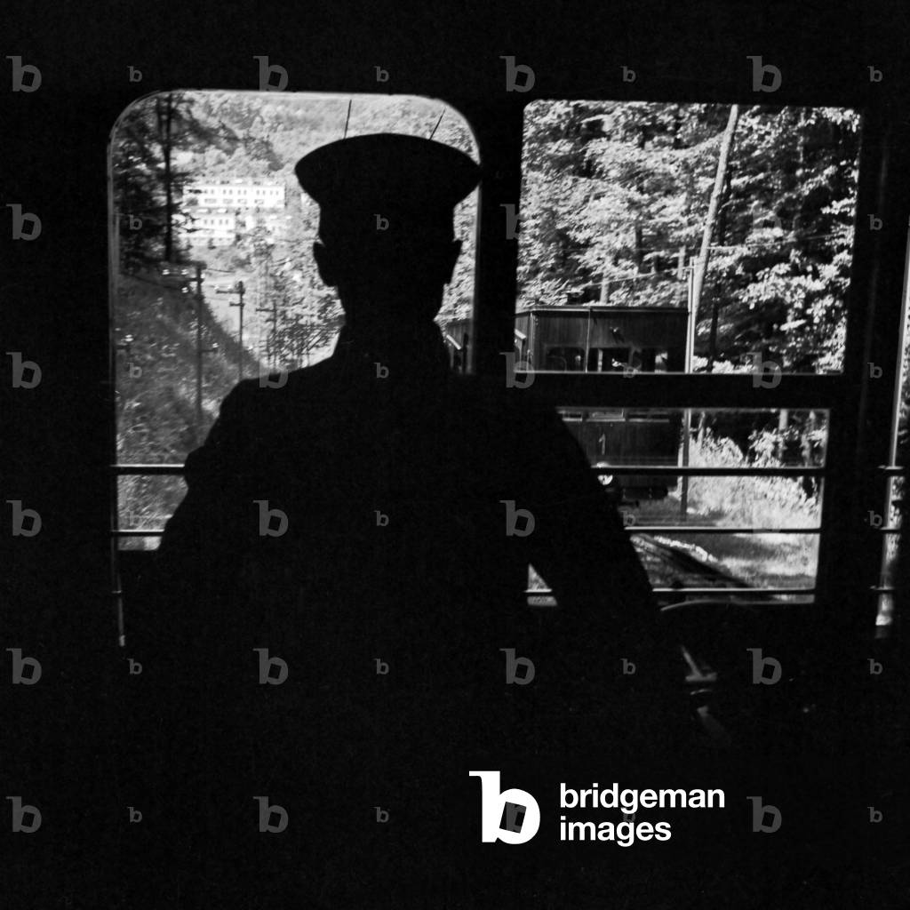 Driver of the Stuttgart cog railway at his cab, Germany 1930s (b/w photo)