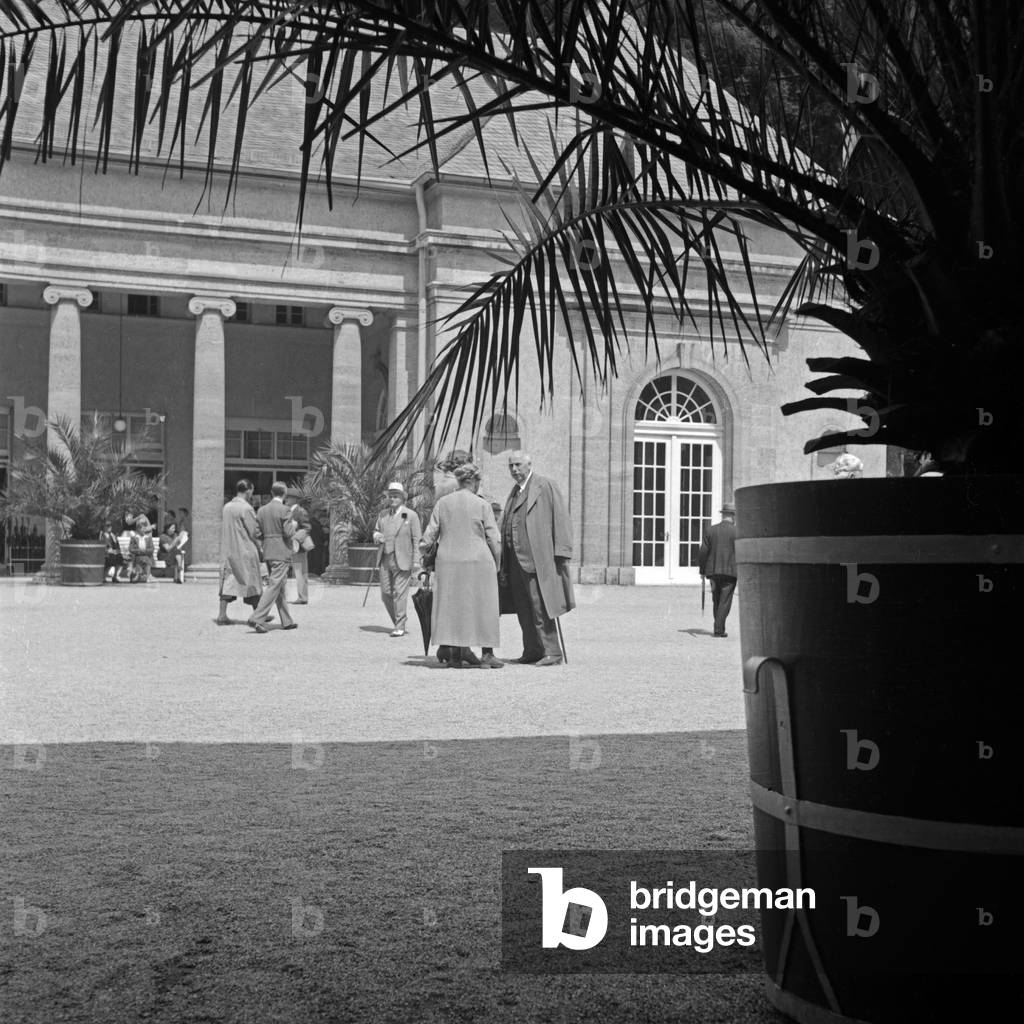 Spa guest in front of the spa resort at Bad Wildungen, Germany 1930s (b/w photo)