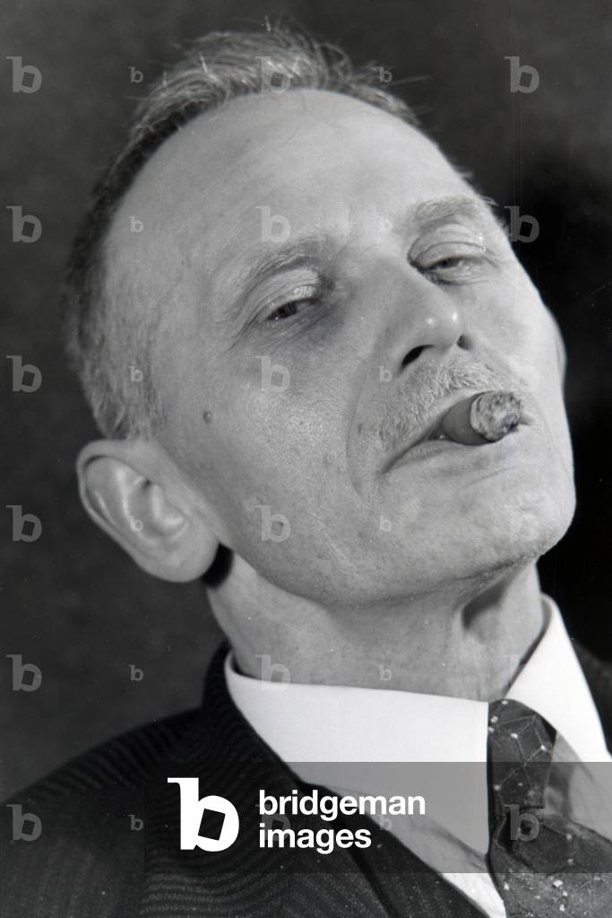A man smoking a cigar for an advertising campaign, Germany 1930s (b/w photo)