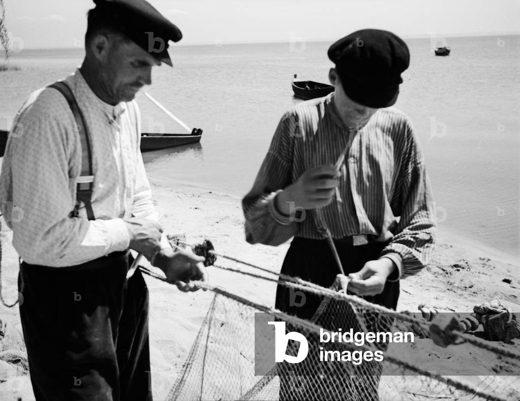 Fisherman repairing their nets at Fischhausen bay, East Prussia, 1930s (b/w photo)
