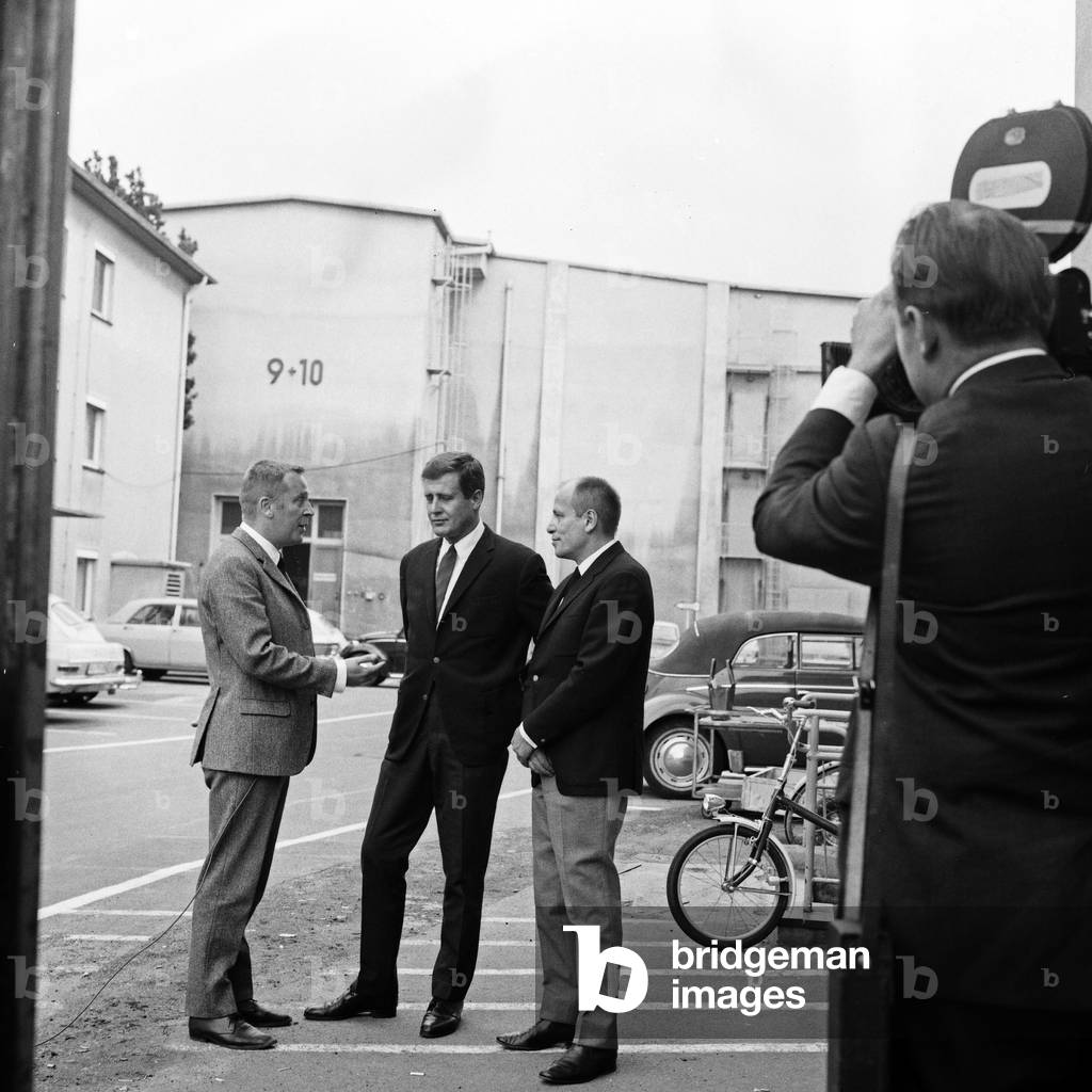German TV directors Harald Vock (center) and Juergen Roland (right) being interviewed, Germany 1960s