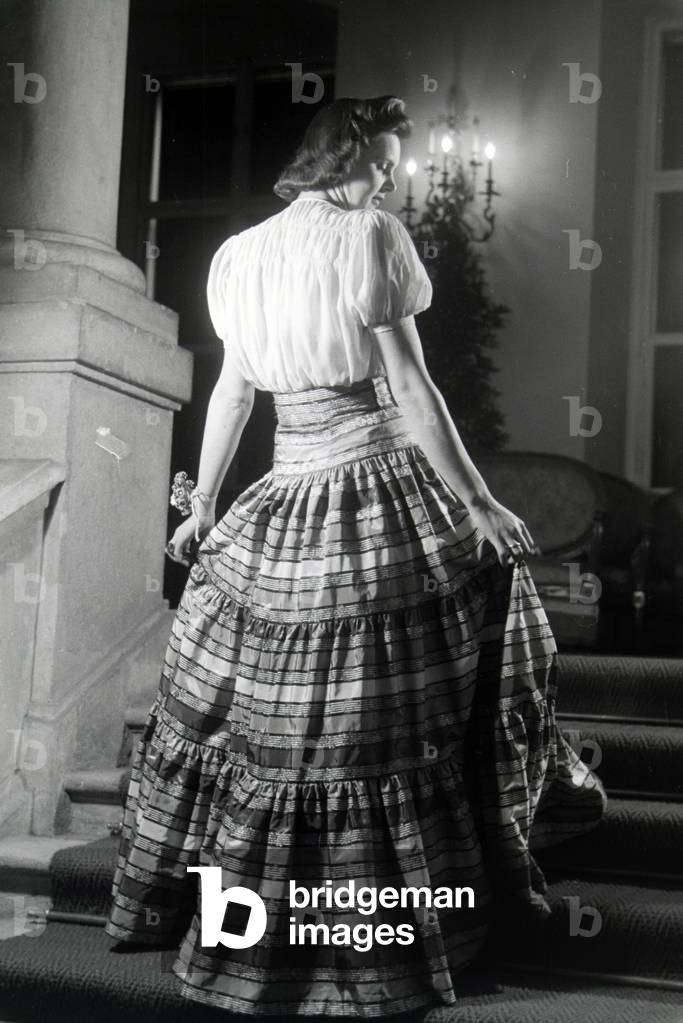 A model is presenting a folkloristic dress, on the occasion of the Wiener Modewoche in the house of fashion 
