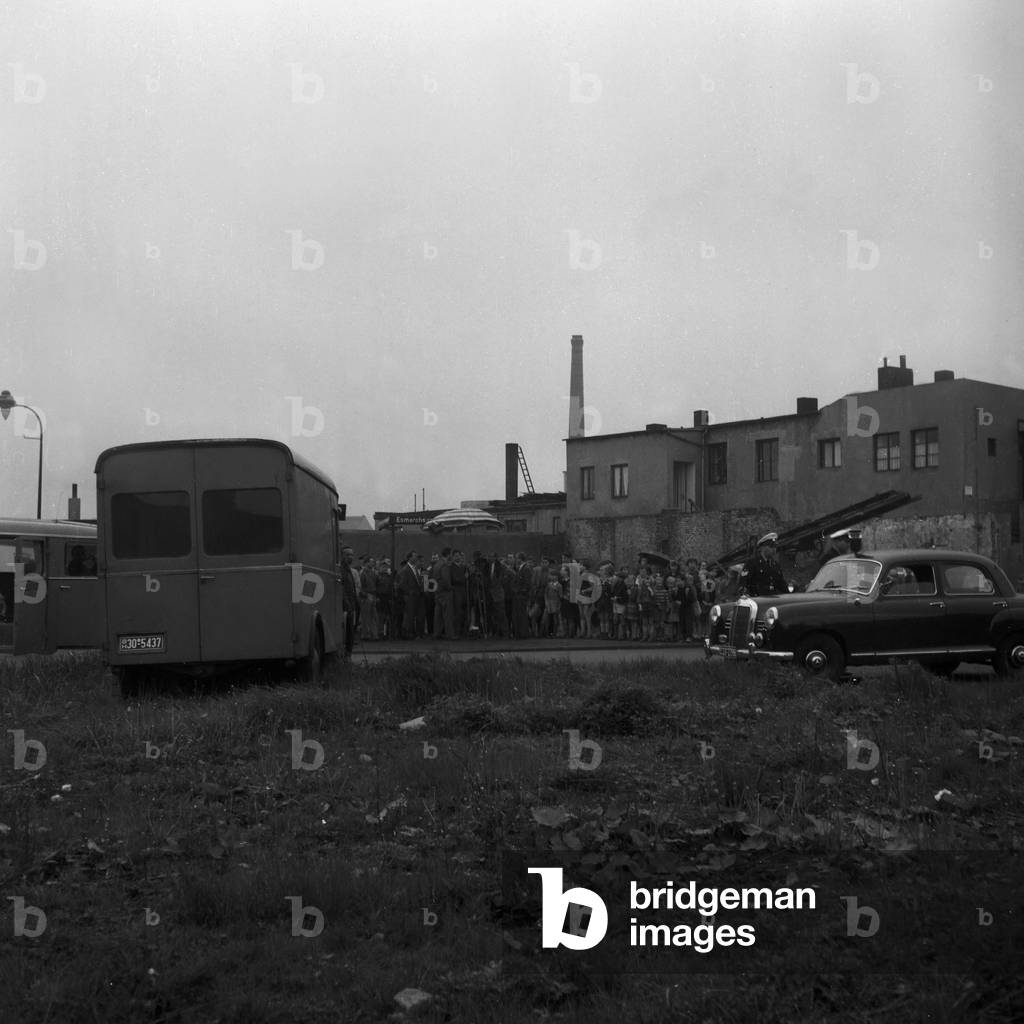 Spectators and a TV crew at the coverage about a bomb deactivation