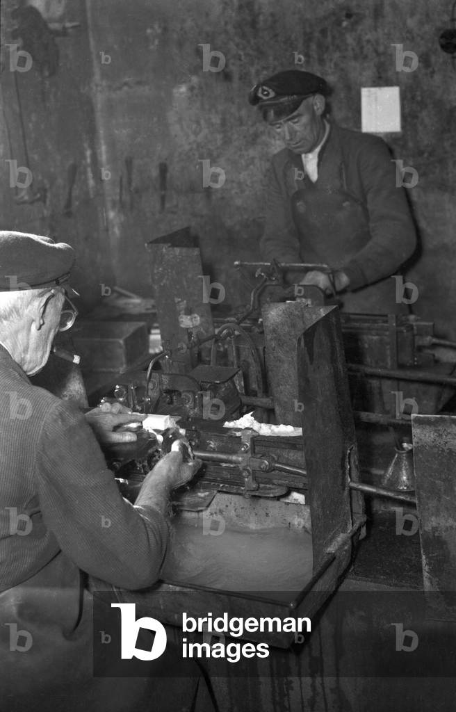 Workers grinding little pieces of ivory, Germany 1954