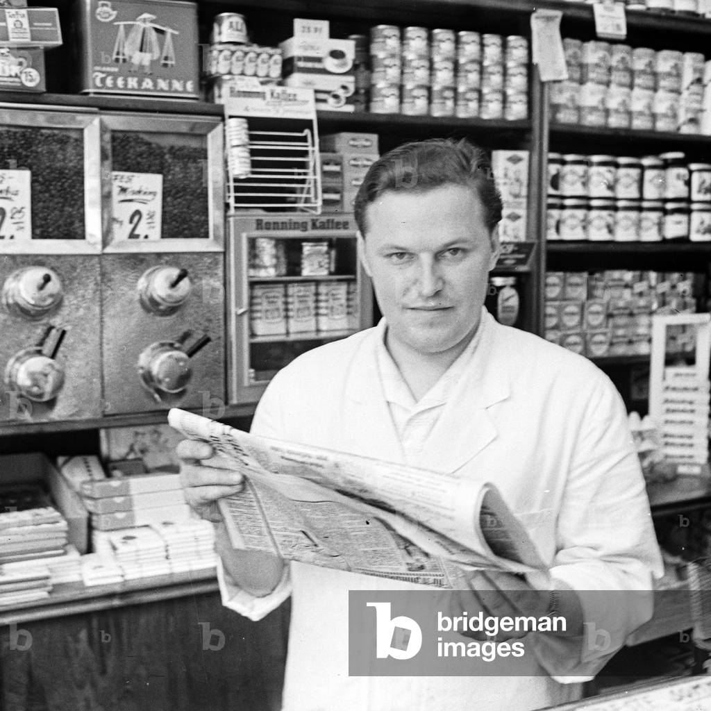 The owner of a corner shop reading the newspaper, Germany 1950s