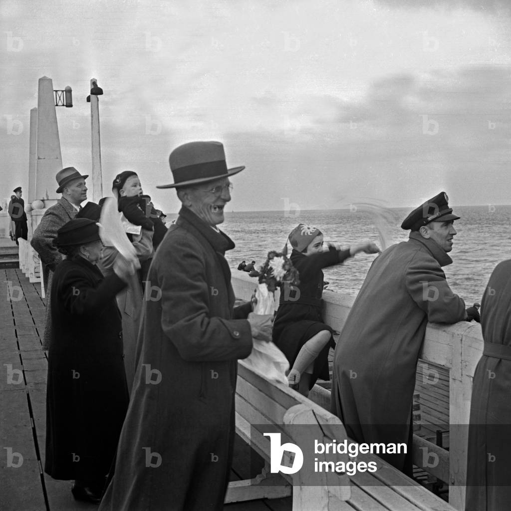Waving friends and families are happy about the arrival of passenger ship 