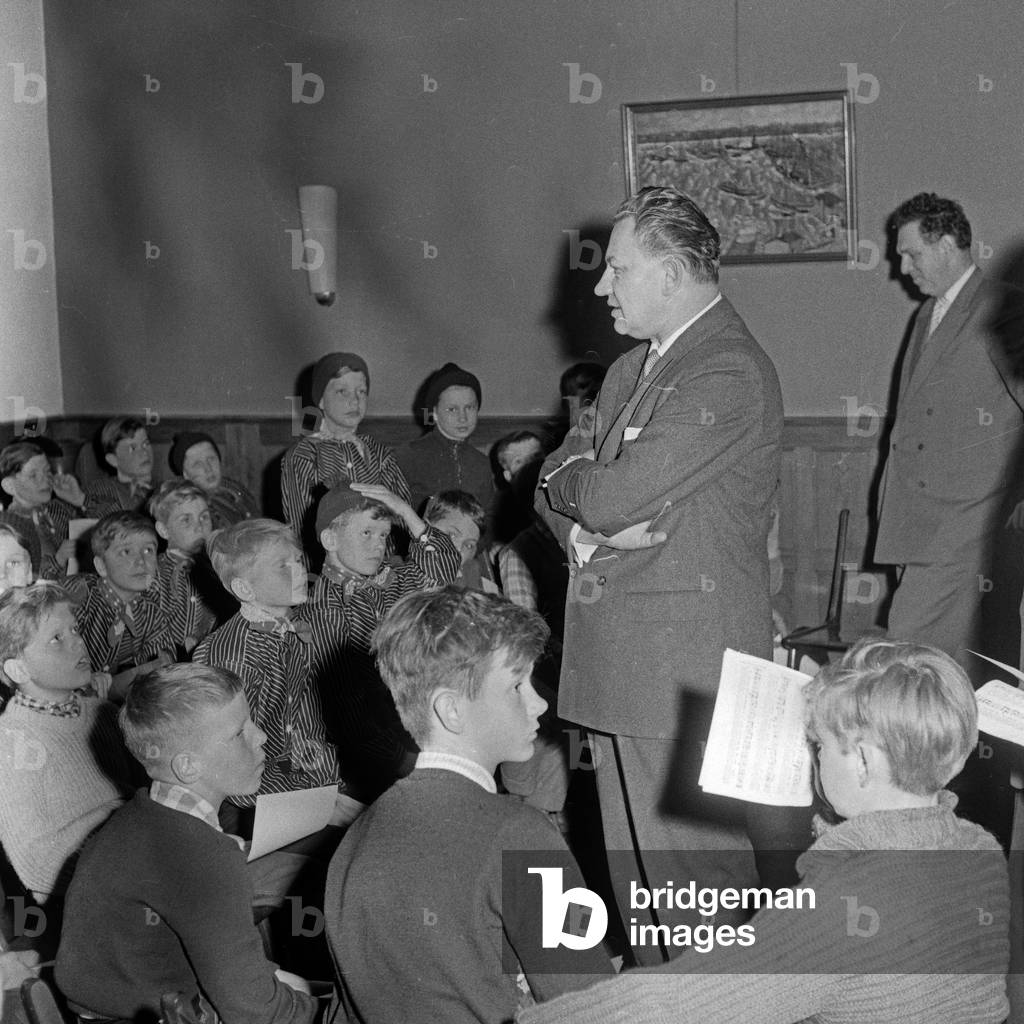 German composer Michael Jary with a children's choir at Hamburg, Germany 1960s