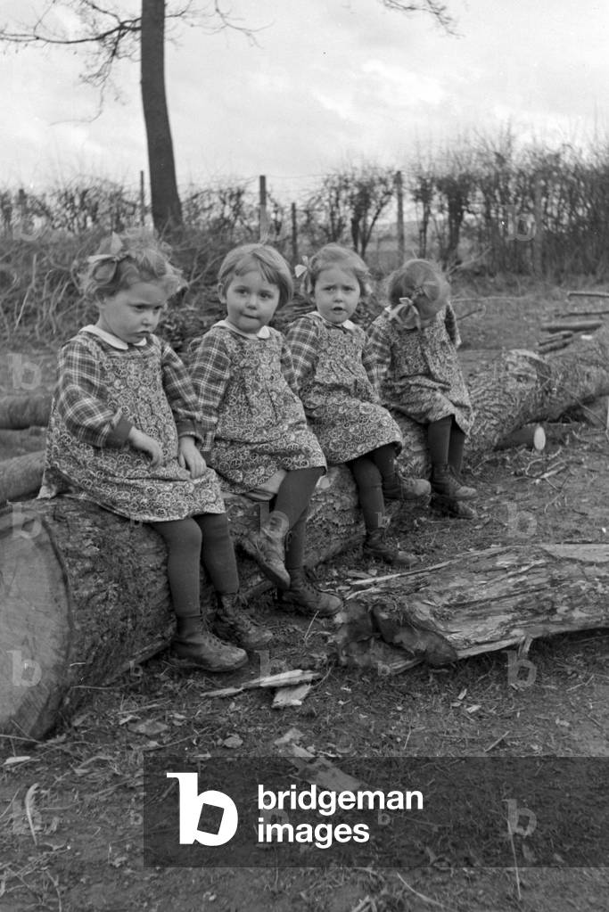 The Knipser's quadruplet girls playing at the garden, Germany 1930s (b/w photo)