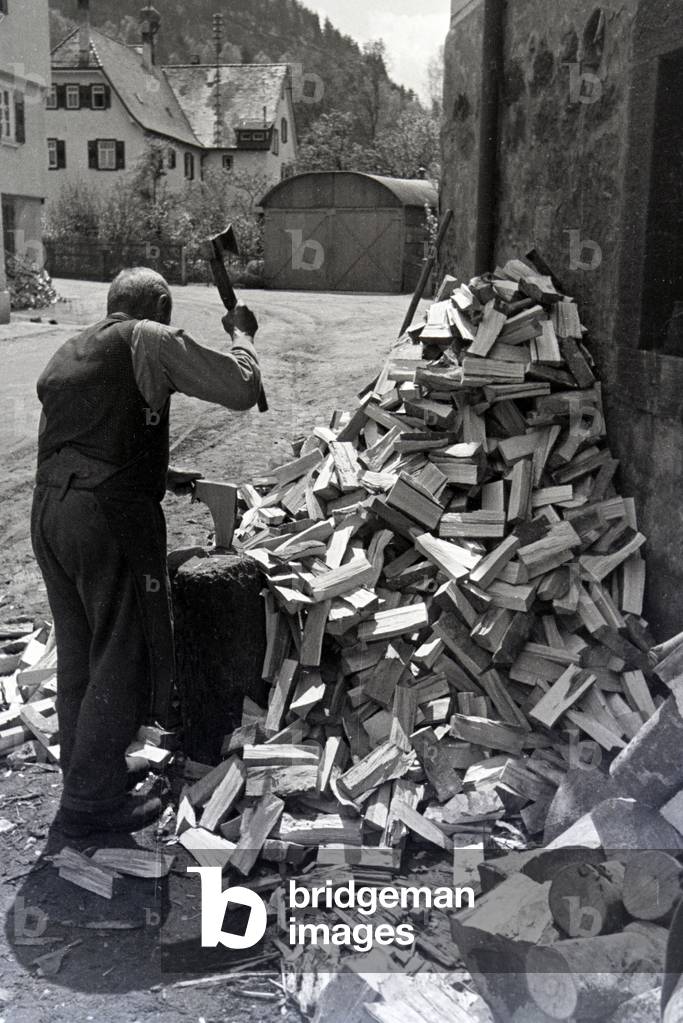 A man chopping wood, Hirsau, Black Forest, Germany 1930s (b/w photo)