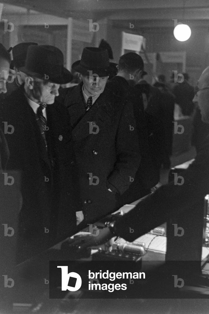 Clients and customers at a booth at Leipzig trade show, Germany 1940s (b/w photo)