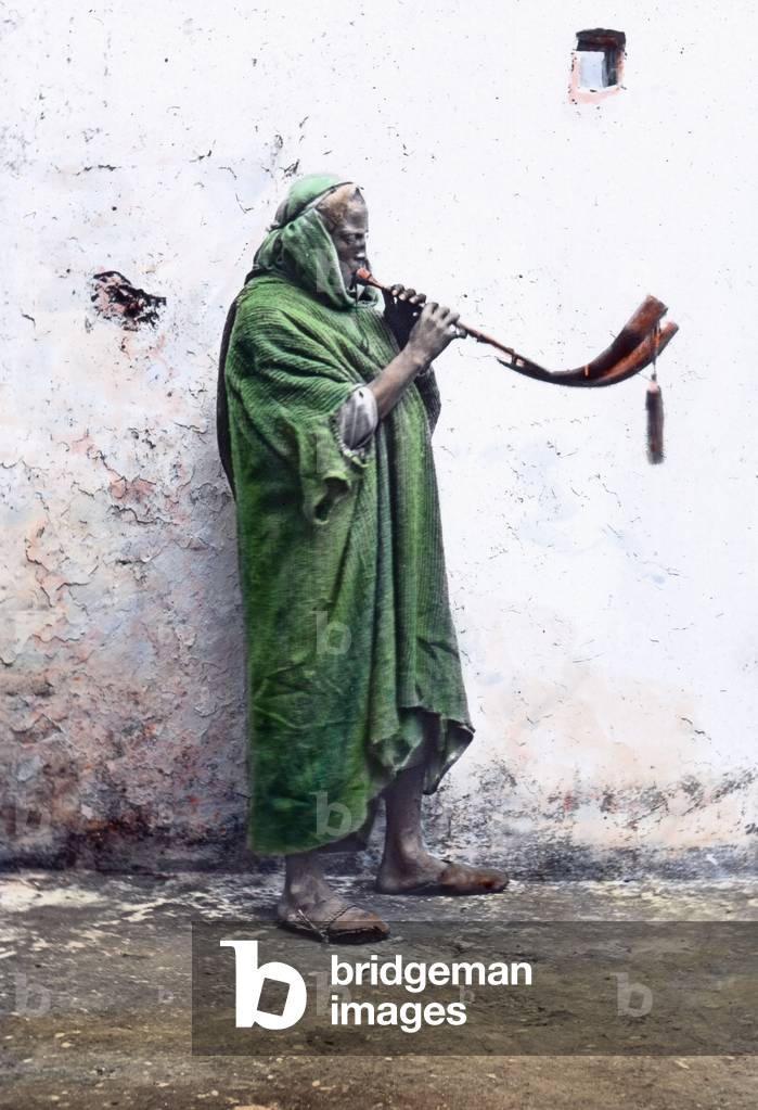 Morocco, horn blower, image date: circa 1910. Carl Simon Archive