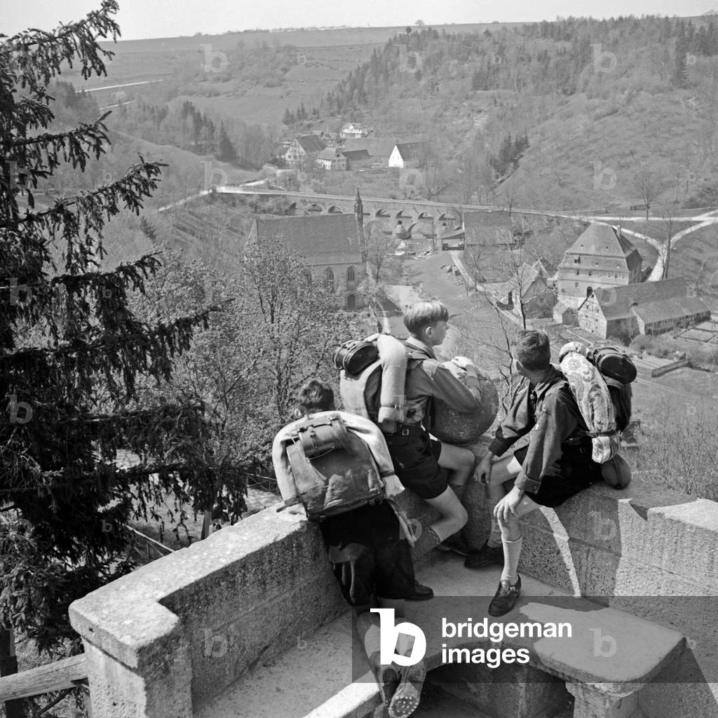 Three Hitler youths watching a village from a watchout, Germany 1930s (b/w photo)