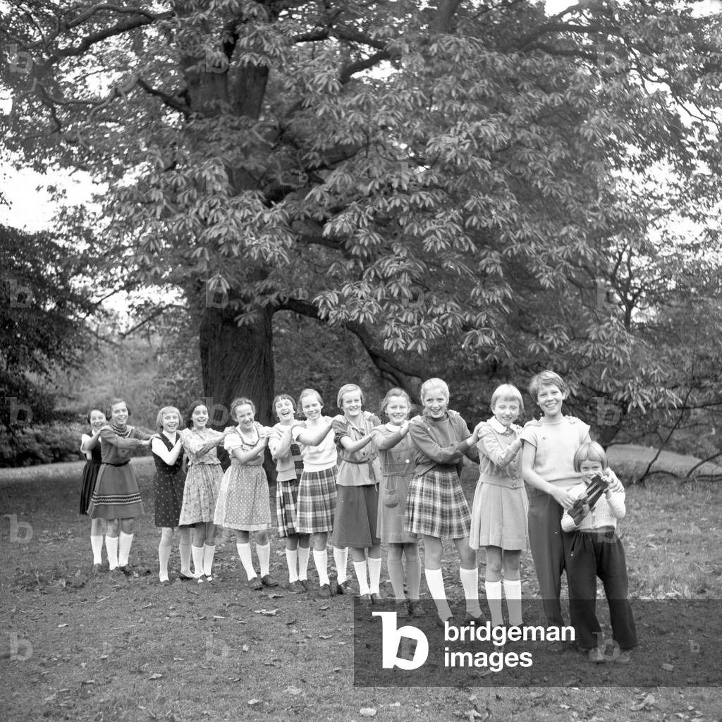 Children posing for a conga line at a park in Hamburg 1954