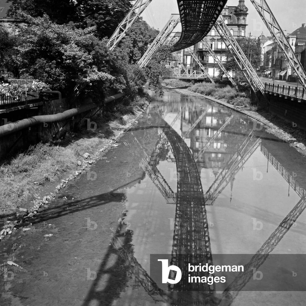 Wuppertal Suspension Railway refelcting in the river Wupper, Germany 1930s (b/w photo)