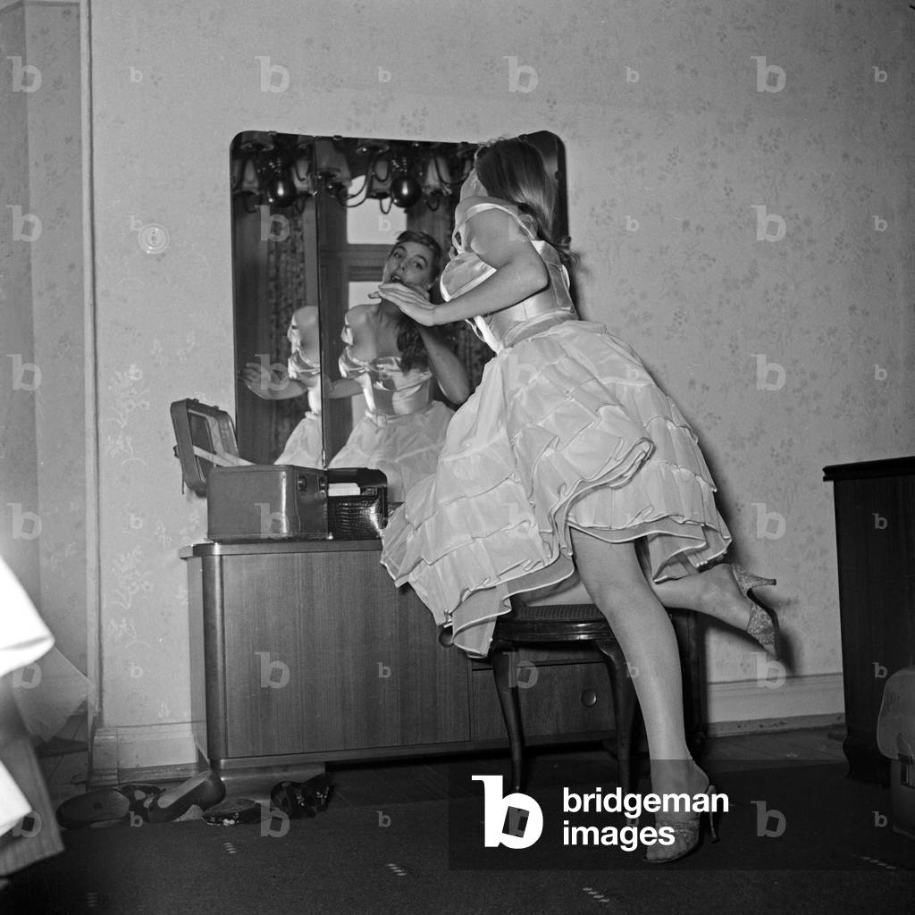 French singer Daniele Dupre at a photo shoot in her hotel room at Hamburg, Germany 1950s