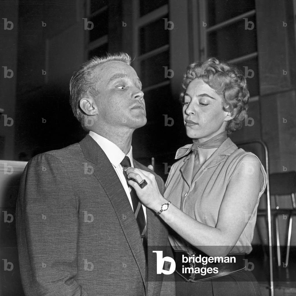 Singer gets his tie checked by singer, Germany 1950s