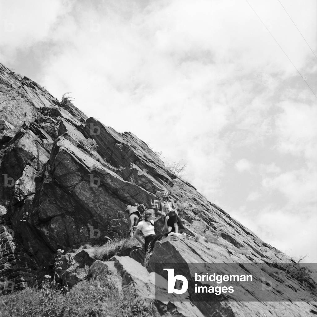 Three young woman reached the peak of a mountain in the Wachau area in Austria, Germany 1930s (b/w photo)