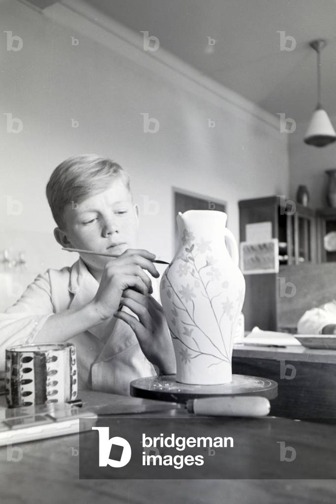 A student of the College for Ceramics working on the pottery wheel in the working ateliers, Höhr-Grenzhausen, Germany 1930s (b/w photo)