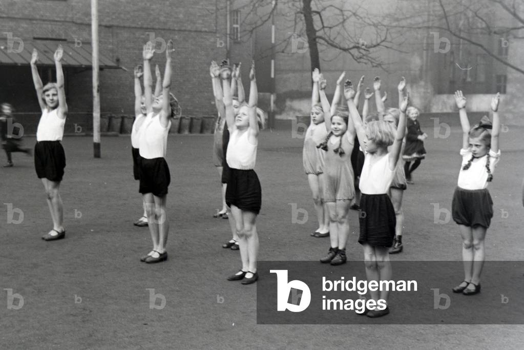 The quadruplets of Brücken taking a sports class, Germany 1930s (b/w photo)