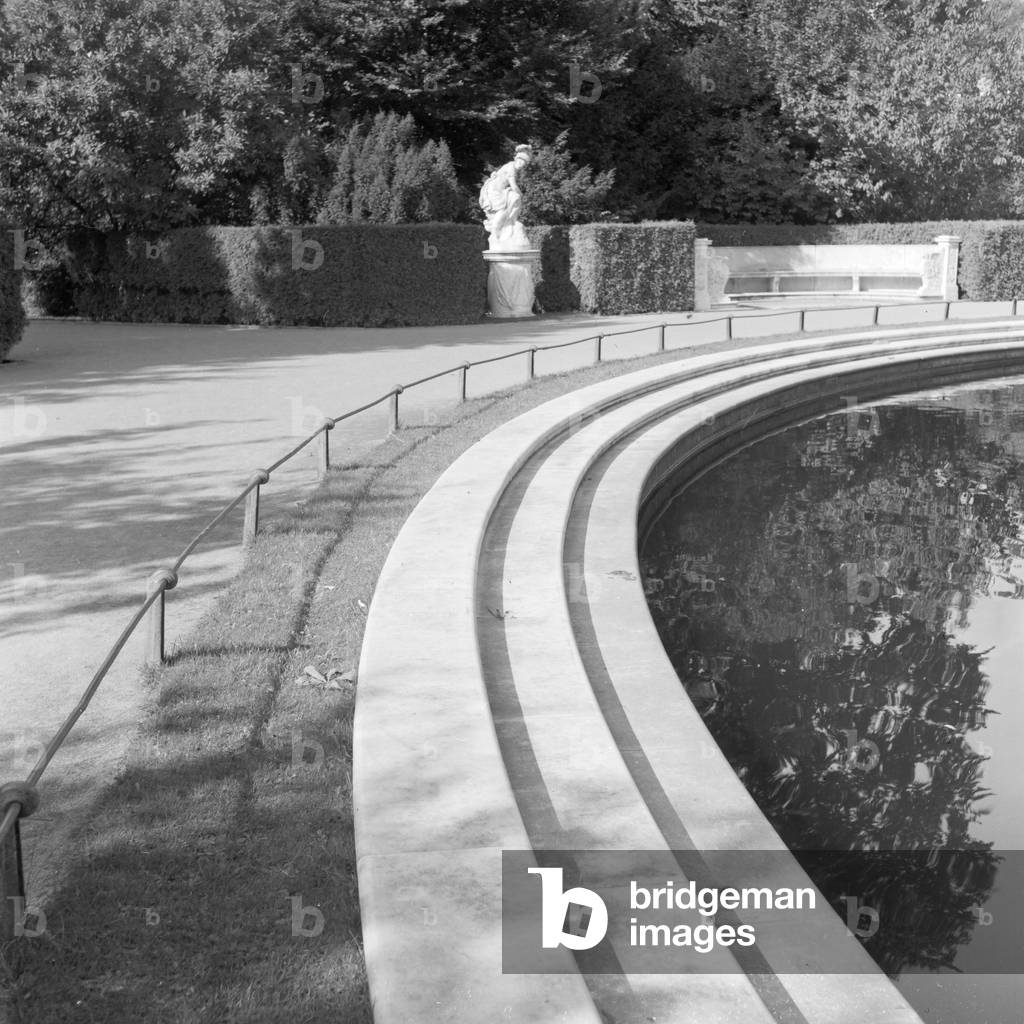 At the gardens of Sanssouci castle at Potsdam, Germany 1930s (b/w photo)