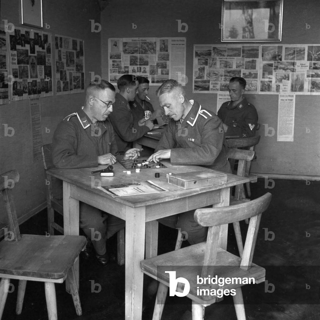 Free time at the barracks - playing draughts at the recreation room, Germany 1940s (b/w photo)