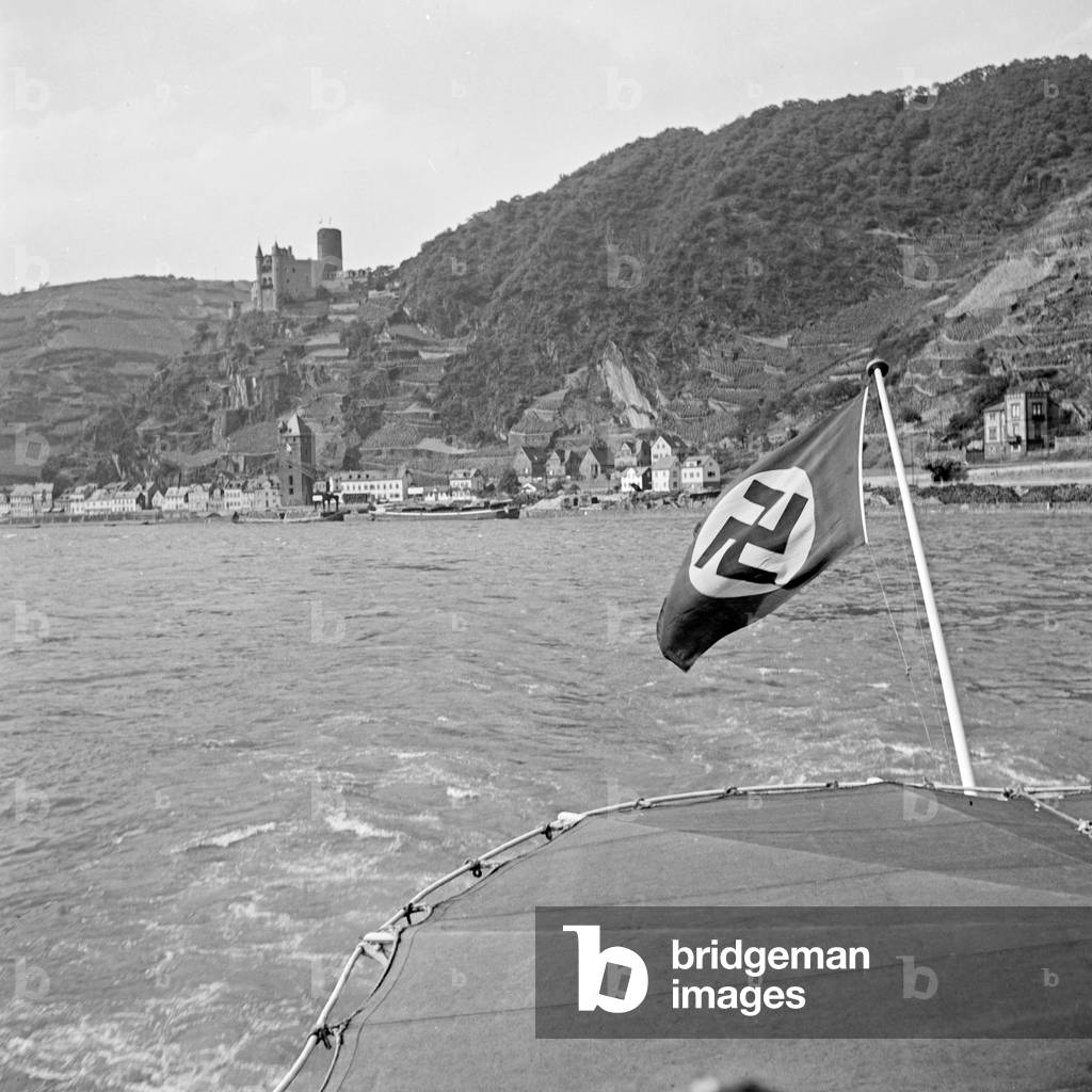 Remains of castles of the middle Rhine valley seen from the stern of a river cruising ship, Germany 1930s (b/w photo)