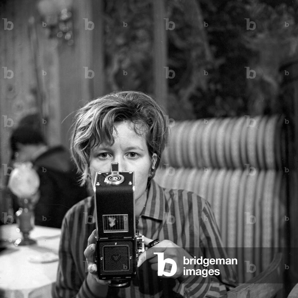 A young woman with a camera at a movie set, Germany 1960s