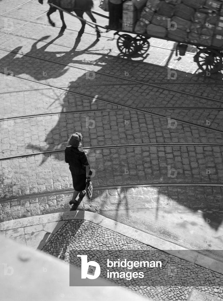 A woman on a street in a city, Germany 1930s (b/w photo)